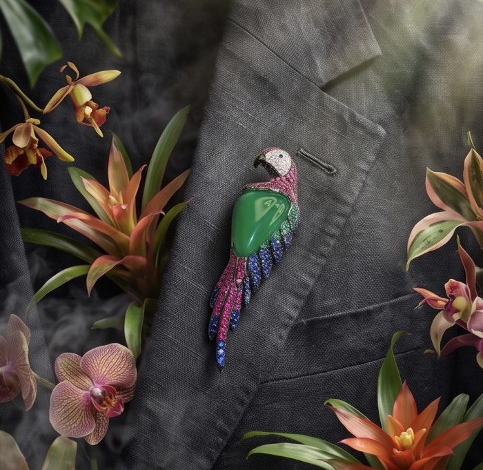 Vibrance & Joy - exotic Parrot - Genuine 22.4 carat Jade from New Zealand .925 Sterling Silver dipped in rhodium handmade Pendant - Brooch - Parrot brooch on suit with orchids, showcasing jade and colorful gems.
