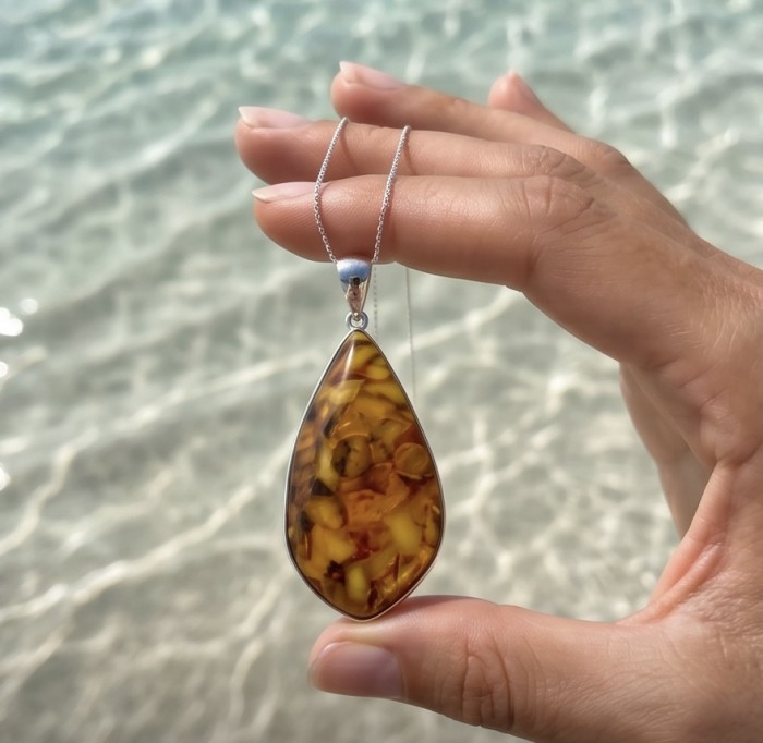 Rare!- vintage Style - natural Baltic Amber .925 Sterling Silver handcrafted HUGE necklace - Close-up of teardrop Baltic amber pendant held over water.
