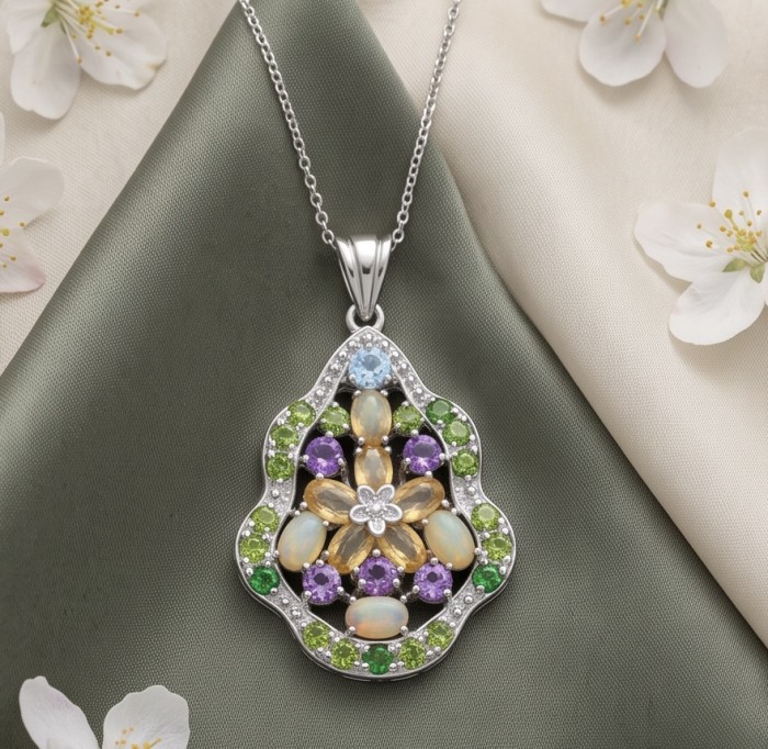 Giovanna - Authentic 18.9 carat Brazilian Citrine .925 Sterling Silver dipped in rhodium handcrafted Statement pendant - Floral gemstone pendant on chain, top-down view with floral backdrop.