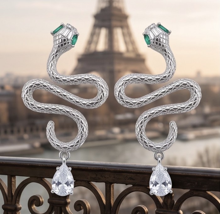 Very Unique Snakes .925 Sterling Silver handcrafted earrings - Snake design silver earrings with emerald detail, Eiffel Tower backdrop.