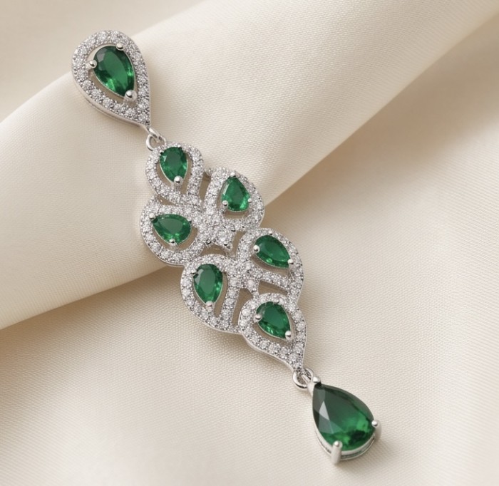 Authentic 6.5 carat Tsavorite Garnet rhodium over .925 Sterling Silver handmade Statement Pendant - Elegant earring with green gemstones and diamonds, on ivory fabric backdrop.