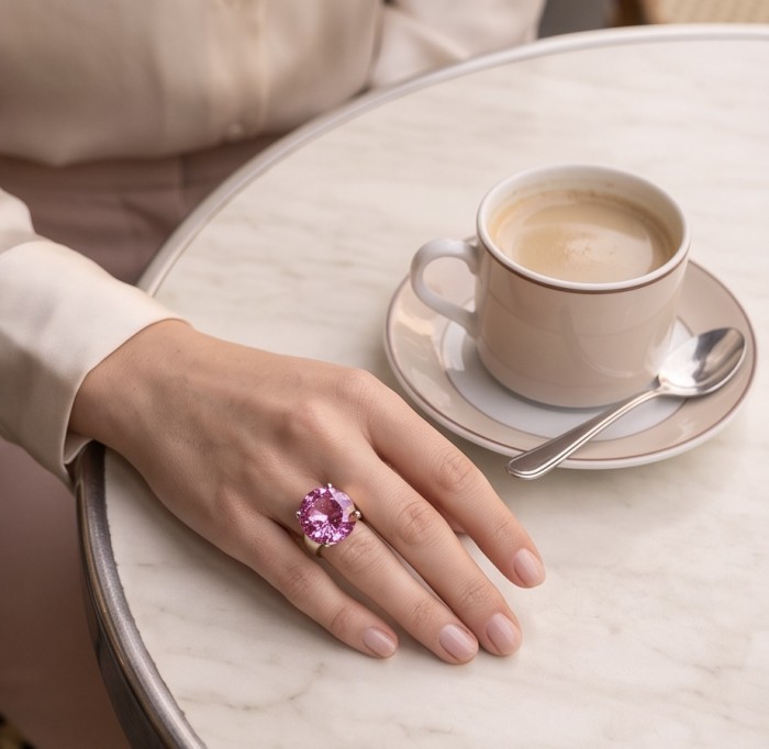 Anastasia 12.2 carat Pink Sapphire .925 Sterling Silver dipped in Rhodium Handcrafted Statement Ring size 6 3/4 - Pink Sapphire ring worn on hand next to coffee on marble table