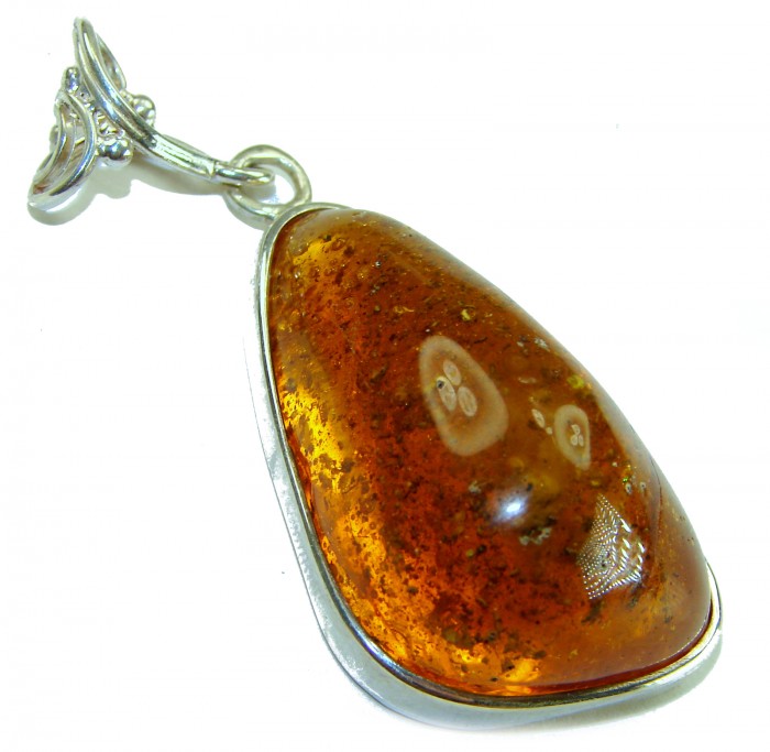 Prehistoric Authentic Golden Baltic Amber .925 Sterling Silver beautifully handcrafted Pendant - Close-up of golden amber pendant in silver setting.