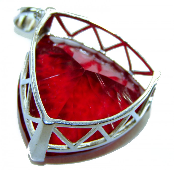 Very Rare! Trillion Cut Perfect 44.5 carat Volcanic Helenite .925 Sterling Silver handcrafted Pendant - Close-up of a trillion cut red gemstone in a silver setting.