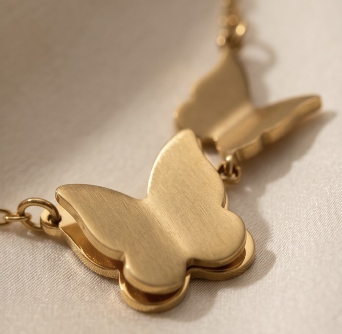 Golden Butterfly 10K Gold over .925 Sterling Silver Italy made necklace - Close-up of golden butterfly necklace detail on fabric background