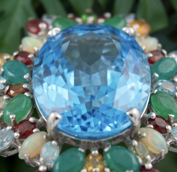 Oceania oval cut 47.8 carat Swiss Blue Topaz .925 Sterling Silver dipped in rhodium Handcrafted Pendant Brooch - Stone close-up of Oceania oval Swiss Blue Topaz with colorful accents