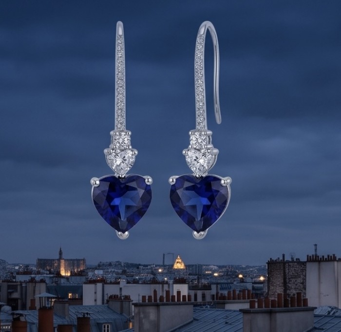 Vintage style - Giovanna - 6.8 carat Sapphire .925 Sterling Silver handcrafted earrings - Heart-shaped sapphire earrings, front view, with city skyline background.