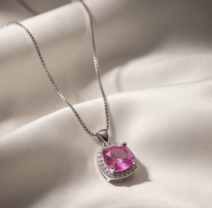 Isabella - delicate 1.9 carat Pink Sapphire .925 Sterling Silver handcrafted Statement Necklace - Pink sapphire pendant in sterling silver, close-up view on satin fabric.