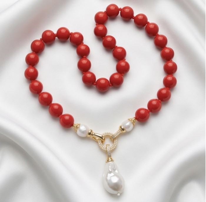Konstancia Sublime natural Red Fossilized Coral Sterling Silver handmade Necklace - Red fossilized coral necklace with pearl pendant on silk fabric backdrop.
