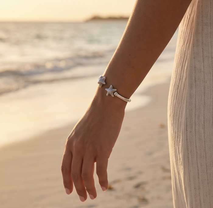 Seaside Italy made Starfish Bracelet in best quality .925 Sterling Silver - Starfish bracelet worn on hand, seaside background, close-up view