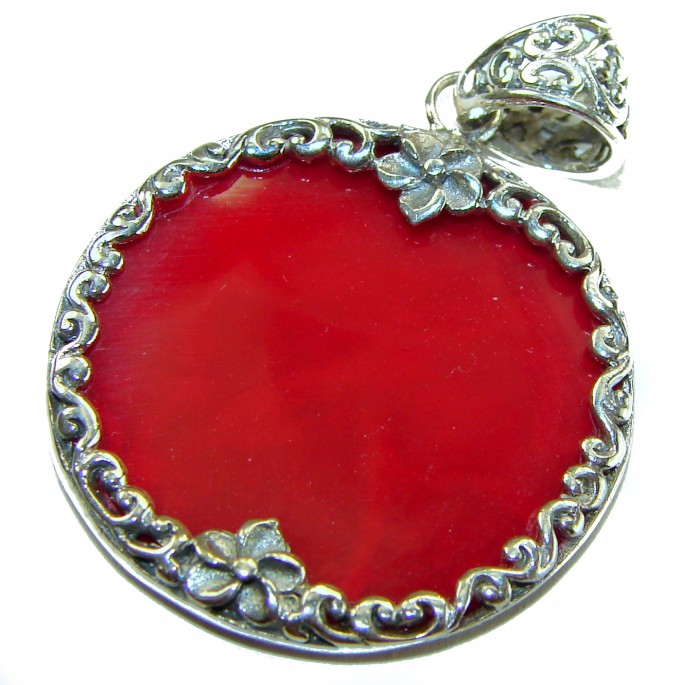 Bright Energy Authentic Coral .925 Sterling Silver Bali handmade pendant - Close-up of coral pendant with ornate silver floral design.