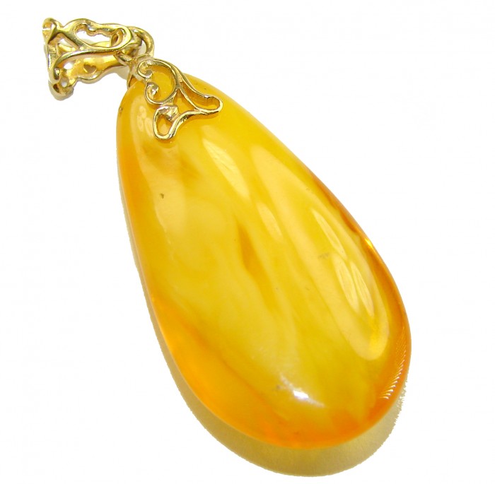 Prehistoric Authentic Baltic Amber REAL 14k Gold beautifully handcrafted Pendant - Golden amber pendant with intricate 14k gold filigree from side view.