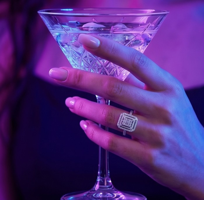 Esmeralda - Precious 10.5 carta White Topaz rhodium over .925 Sterling Silver Statement ring size 6 1/2 - Close-up of Esmeralda ring on hand holding a martini glass.