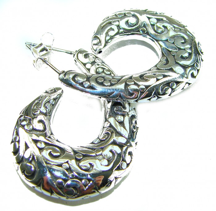 1 5/8 inches long - Free Spirit bohemian Style .925 Sterling Silver handmade Bali made Oversized Earrings - Ornate silver earrings with swirled design, top angle view.