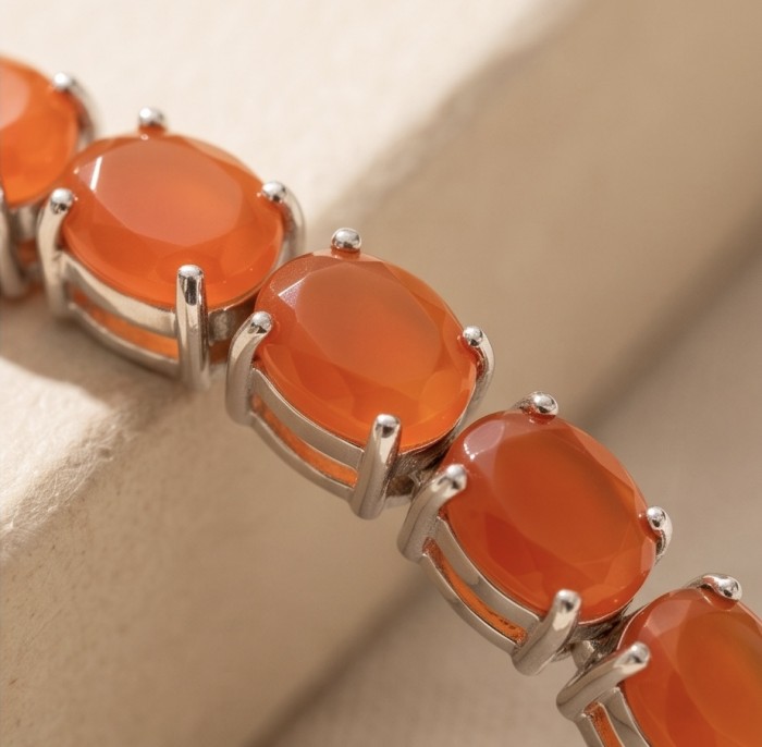 Sublime Brilliance 26.8 carat Authentic Orange Fire Opal .925 Sterling Silver handcrafted bracelet - Close-up of orange fire gemstones set in a bracelet.