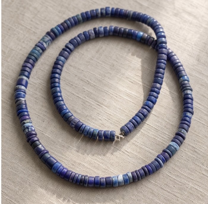 Boho Style 55.2 carat Lapis Lazuli .925 Sterling Silver handmade necklace - Boho Lapis Lazuli necklace on fabric, showcasing bead details.