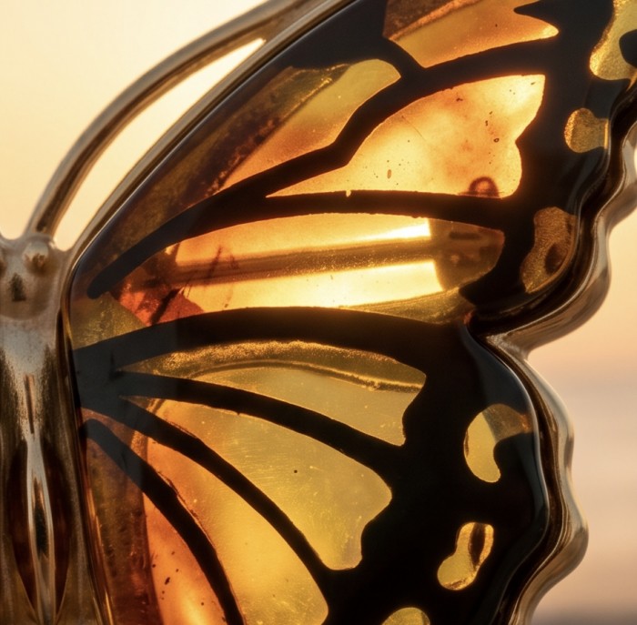 Golden Butterfly Authentic carved Baltic Amber 18K Gold over .925 Sterling Silver handcrafted pendant - Close-up of golden butterfly Baltic amber jewelry detail.