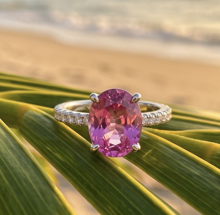 Tiffany - authentic oval cut 4.5 carat Pink Sapphire .925 Sterling Silver Handcrafted Statement Ring size 8 1/4 - Close-up of pink sapphire ring on palm leaf with beach background.