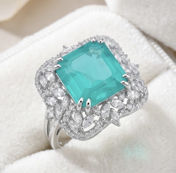 Elizabeth princess cut 14.8 carat Colombian Emerald 12.3 carat Moissanite .925 Sterling Silver dipped in Rhodium handcrafted Ring size 8 - Close-up of a princess cut Colombian emerald ring with diamond accents