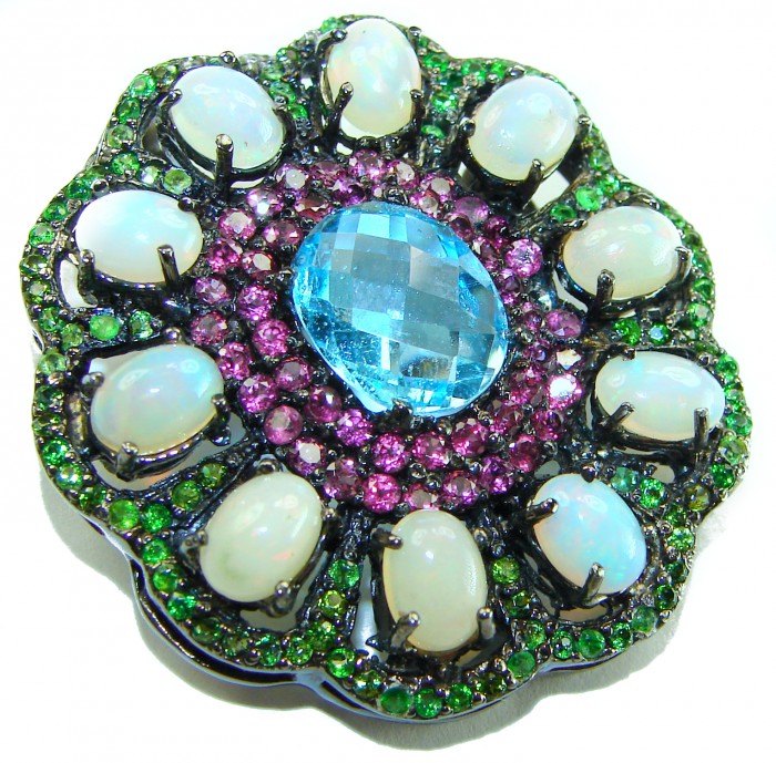 Costa del Sol oval cut 27.8 carat Ethiopian Opal Swiss Blue Topaz .925 Sterling Silver Handcrafted Pendant - Close-up of Costa del Sol opal jewelry with blue and multicolor stones.