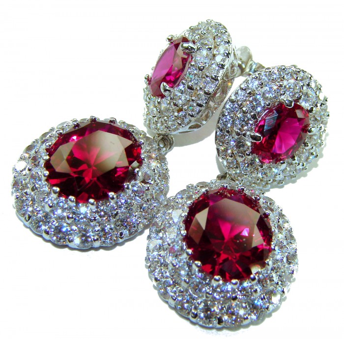 Luxurious natural 10.5 carat Red Topaz .925 Sterling Silver Perfectly handcrafted Earrings - Close-up of red topaz and silver jewelry with intricate stone detailing.