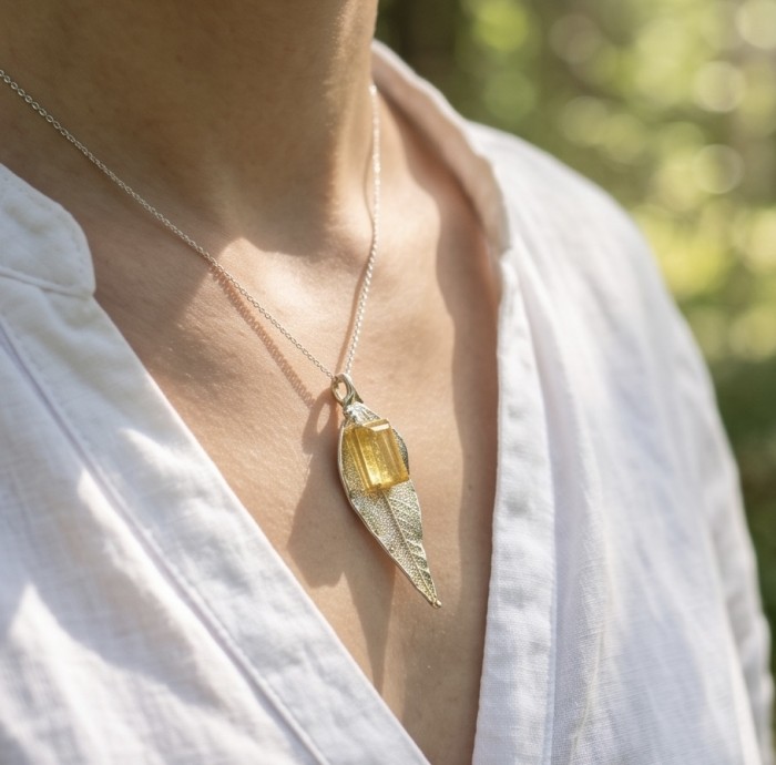 Stylish REAL Leaf dipped in Gold 11.5 carat Garnet .925 Sterling Silver Pendant - Gold-dipped leaf pendant with garnet, worn on neck, front view.