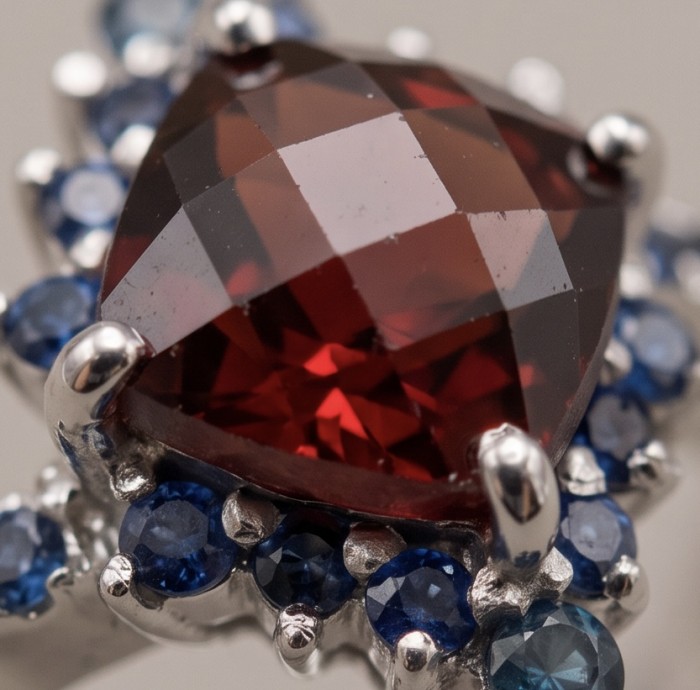 Red Heart 4.8 carat natural Garnet rhodium over .925 Sterling Silver Handcrafted Ring size 8 1/4 - Close-up of red garnet with blue stones in rhodium setting.