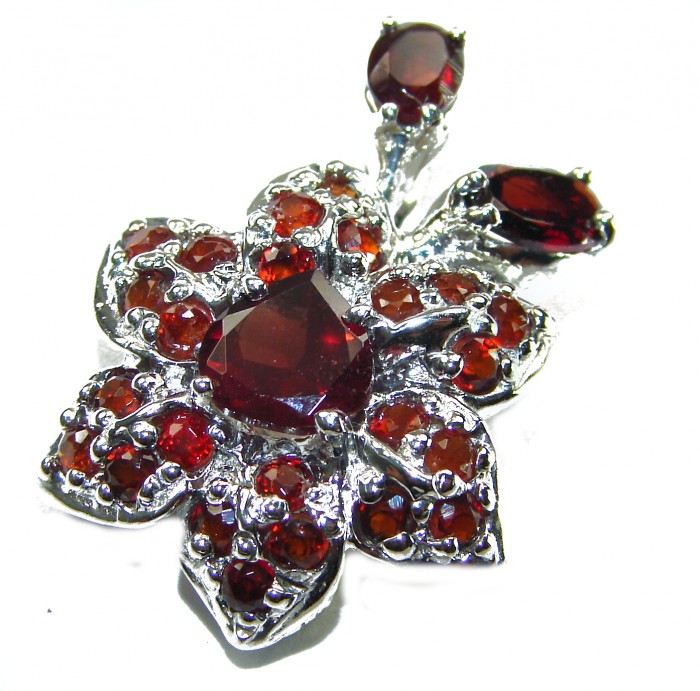 Red Flower Authentic 14.5 carat faceted authentic Australian Garnet .925 Sterling Silver handcrafted Statement Pendant - Close-up of red gemstone flower brooch with intricate details.