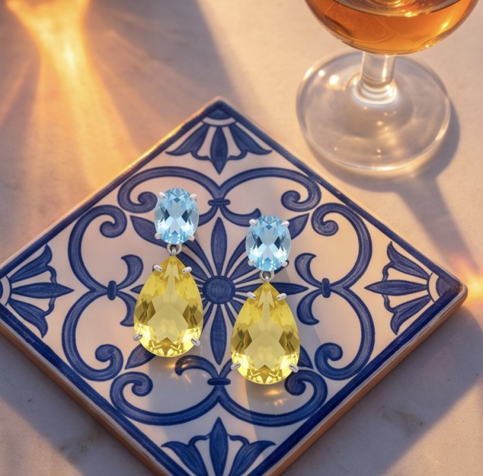 Giovanna - Authentic 27.9 carat Brazilian Citrine .925 Sterling Silver dipped in rhodium handcrafted earrings - Earrings on tile with blue topaz and citrine stones, aerial view.
