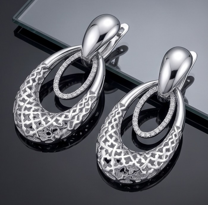 Highly Polished Fancy design 3.2 carat White Topaz .925 Sterling Silver Italy made Earrings - Close-up of polished white topaz earrings with intricate design.