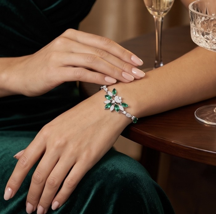 Giovanna - Authentic 6.2 carat Colombian Emerlad .925 Sterling Silver handcrafted Statement bracelet - Emerald bracelet worn on wrist with green dress and crystal glass.