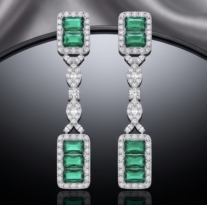 Art Deco Spectaculat 4.5 carat Colombian Emerald .925 Sterling Silver handcrafted earrings - Art Deco earrings with emeralds and diamonds on reflective surface