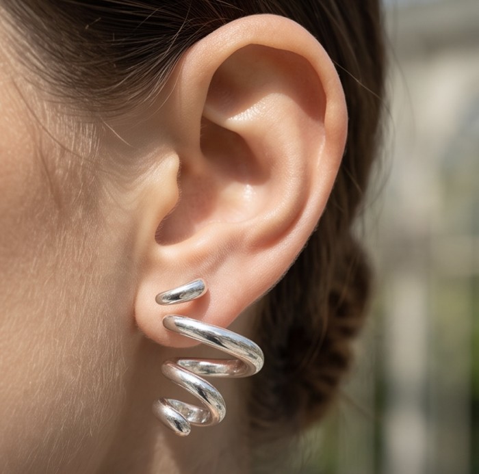 Spiral design Italy made .925 Sterling Silver handcrafted Earrings - Close-up of spiral design .925 Sterling Silver earring worn on ear