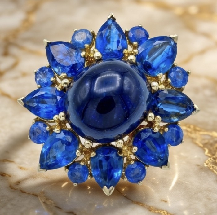 Incredible 22.5 carat Natural Sapphire from Tanzania 18K Gold over .925 Sterling Silver Brooch - Close-up of a natural star sapphire ring with blue gemstones.