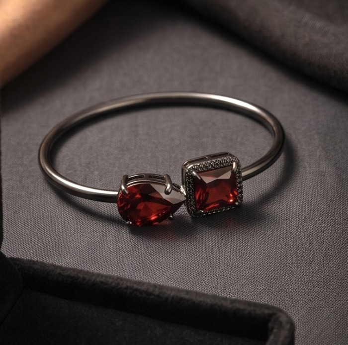 Precious Genuine 8.7 carat Garnet .925 Sterling Silver dipped in black rhodium handcrafted Bracelet - Close-up of garnet and silver bracelet on dark fabric background