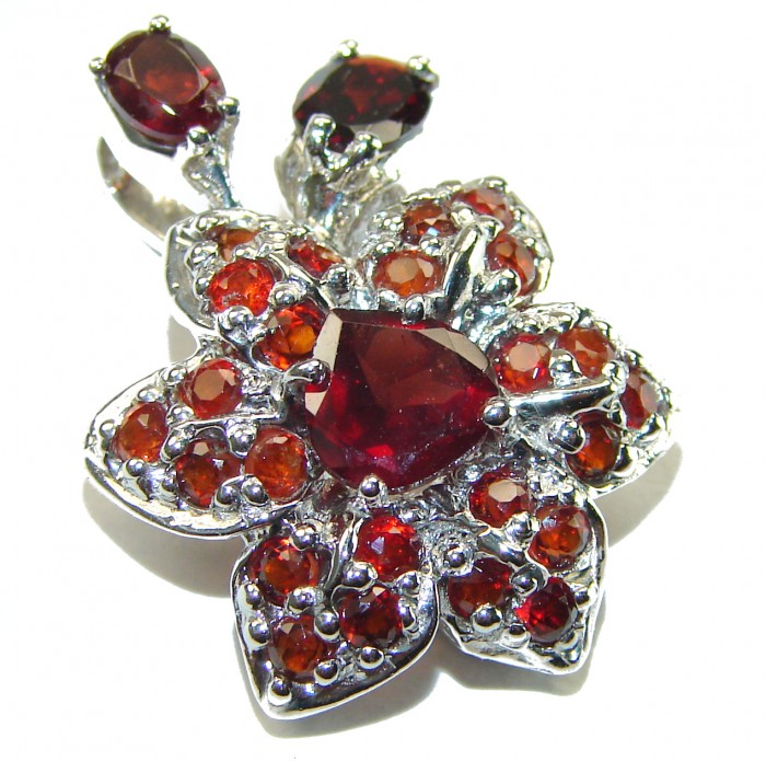 Red Flower Authentic 14.5 carat faceted authentic Australian Garnet .925 Sterling Silver handcrafted Statement Pendant - Close-up view of red flower-shaped gemstone jewelry with silver detailing.