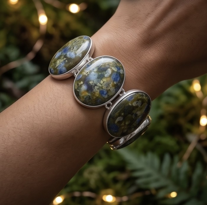 Bochemian Style Beauty 149.5 carat Rare Stichtite .925 Sterling Silver handcrafted Bracelet - Bohemian bracelet with Stichtite stones, worn on wrist, leafy backdrop