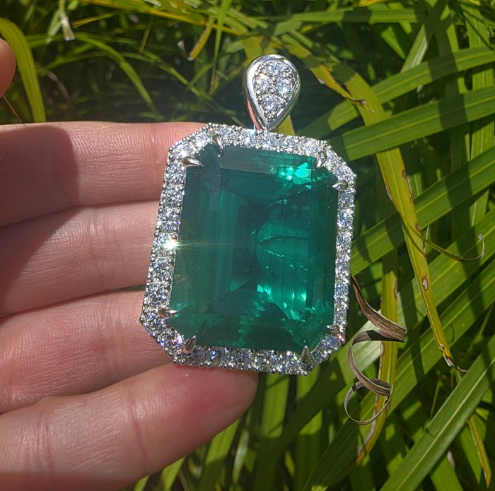 Rare finding! Deluxe 55.2 carat authentic baquette cut Emerald rhodium over .925 Sterling Silver handmade Statement Pendant - Close-up of a 55.2 carat emerald pendant with diamond accents.