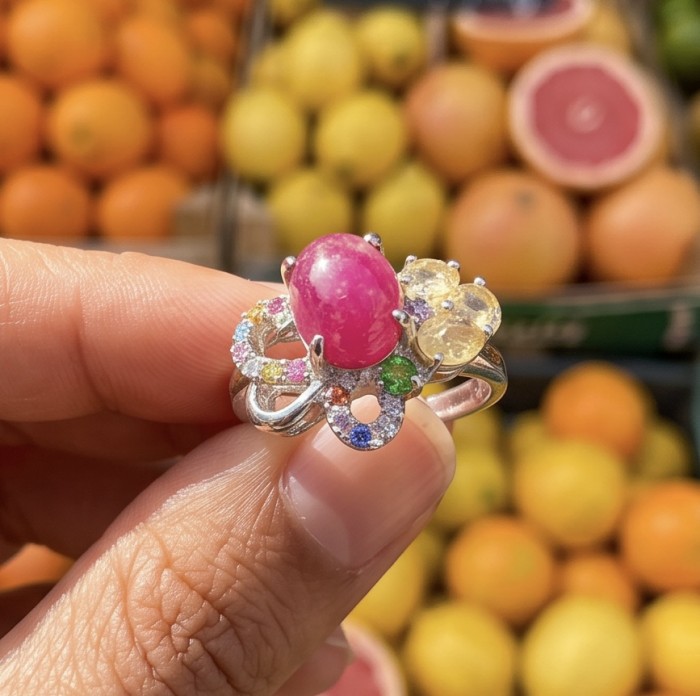 My Sweet Heart Natural 4.8 carat Mozambique Ruby .925 Sterling Silver Handcrafted Cocktail Ring s. 9 - Ruby ring stone close-up with colorful gems in background fruits.
