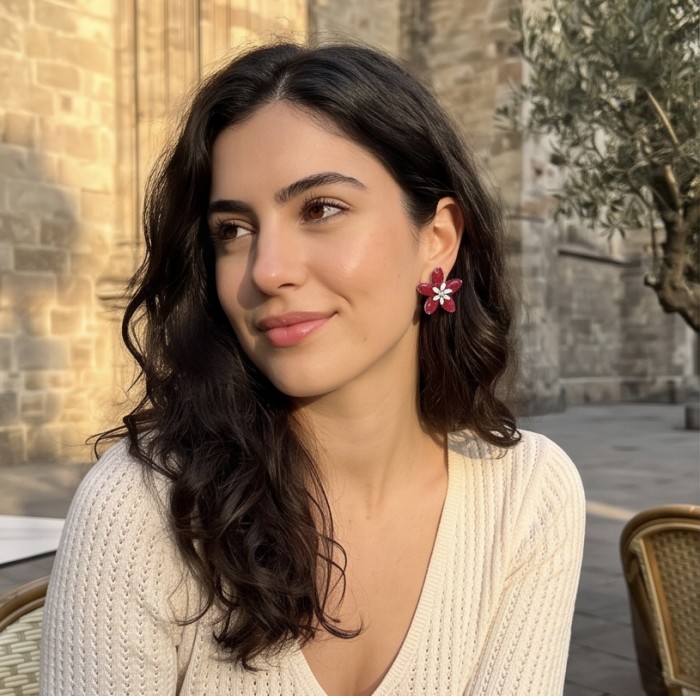 Giuseppina - mystery setting 7.8 carat authentic Ruby .925 Sterling Silver handcrafted Statement earrings - Woman wearing Giuseppina ruby earrings outdoors.