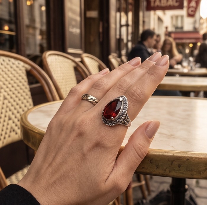 Red Power Authentic 25.4 carat Garnet .925 Sterling Silver brilliantly handcrafted large Statement Ring size 7 1/4 - Garnet ring on hand, close-up, in a café setting.