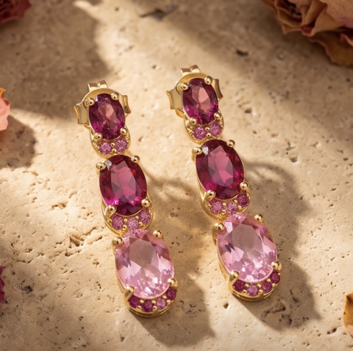 Isabella - natural 7/8 inch long Mozambique Ruby 18K Gold over .925 Sterling Silver handmade Statement earrings - Close-up of Isabella earrings with rubies and gold on stone background