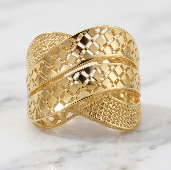 Dubai Style .925 Sterling Silver dipped in 22K Gold handmade Large ring size 8 - Angled view of gold lattice pattern band on marble surface.