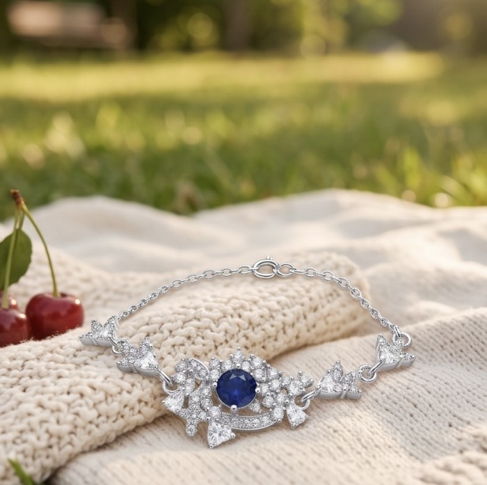Vintage style - Giovanna - oval pear cut 6.8 carat Sapphire .925 Sterling Silver handcrafted Statement Bracelet - Elegant bracelet with sapphire and diamonds on knit fabric, side view.