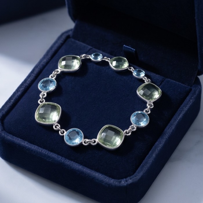 Authentic 22.5 carat Swiss Blue Topaz .925 Sterling Silver handmade Bracelet - Top-down view of Swiss Blue Topaz bracelet in velvet box.