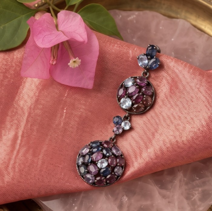 Serenity 22.5 carat Brazilian Watermalon Tourmaline black rhodium over .925 Sterling Silver handmade Pendant - Close-up of Serenity tourmaline earrings on pink fabric with flower.