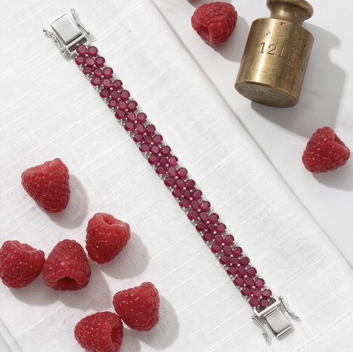 Giuseppina - Magnificent 42.3 carat authentic Ruby rhodium over .925 Sterling Silver handcrafted Bracelet - Top view of ruby bracelet with raspberries on white cloth.