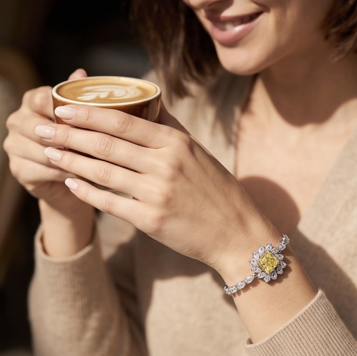 Luxurious 7.5 carat princess cut Yellow Sapphire .925 Sterling Silver handcrafted Statement Bracelet - Worn on wrist, yellow sapphire bracelet with coffee cup.