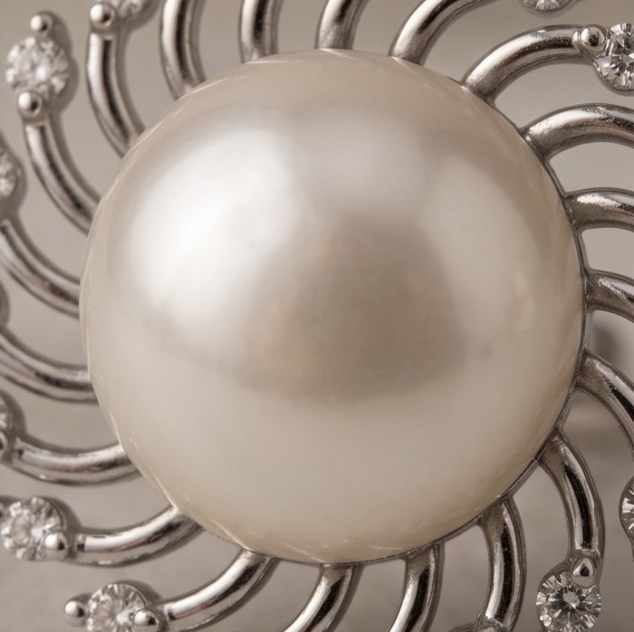 Genuine Pearl .925 Sterling Silver dipped in rhodium handcrafted Statement Earrings - Close-up of pearl and silver design in rhodium-dipped jewelry.