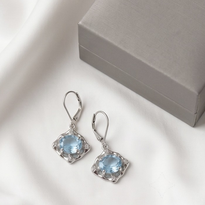 Angelina 8.9 carat authentic Swiss Blue Topaz .925 Sterling Silver Handcrafted Earrings - Swiss Blue Topaz earrings with .925 Sterling, top view on cloth background.